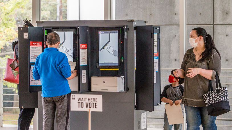 Early voting began Monday in Fulton County.  Voters waited between 2 1/2 and 3 hours to cast ballots in the Anne Cox Chambers Wing of the High Museum of Art, where six ballot stations operated without any major technical problems.  (Jenni Girtman for The Atlanta Journal-Constitution)