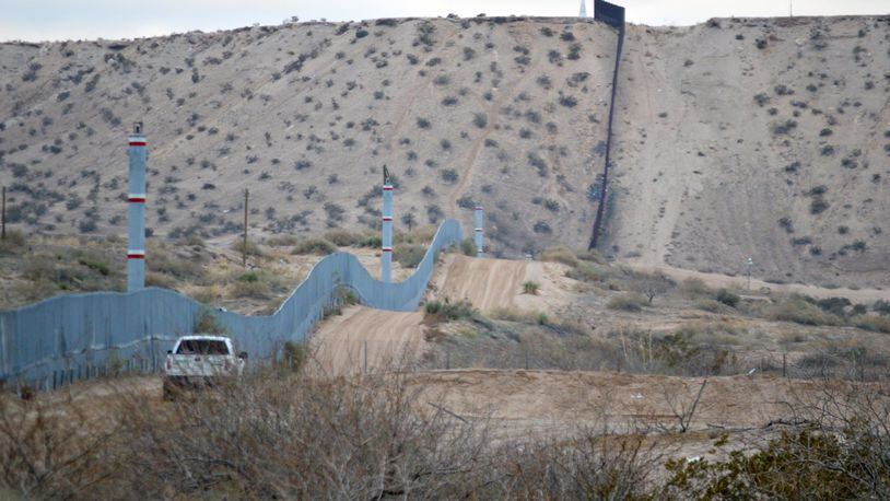 FILE - In this Jan. 4, 2016 photo, a U.S. Border Patrol agent drives near the U.S.-Mexico border fence in Sunland Park, N.M. Can Donald Trump really make good on his promise to build a wall along the 2,000-mile U.S.-Mexican border to prevent illegal migration? What’s more, can he make Mexico pay for it? Sure, he can build it, but it’s not nearly as simple as he says. (AP Photo/Russell Contreras)