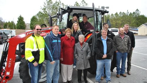 Duluth Public Works Department accepts donation of new tractor. Left to right: Deputy PW Director Jason Brock, Councilman Jim Dugan, Duluth Fall Festival Annette McIntosh, PW Director Audrey Turner, Duluth Fall Festival Katherine Willis, Mayor Nancy Harris, Councilman Kelly Kelkenberg, Councilman Billy Jones, AGCO Tom Kramer, Kabe Cain from Massey Ferguson, and AGCO Toby Bowen. Courtesy of City of Duluth