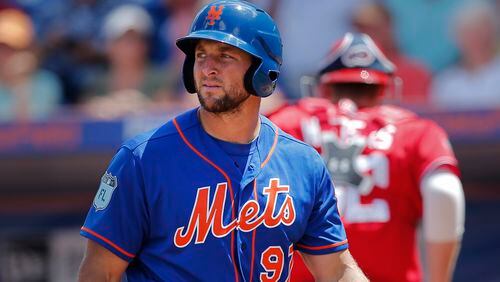 New York Mets' Tim Tebow walks back to the dugout after striking out against the Washington Nationals' Max Scherzer Monday, March 27, 2017, in Port St. Lucie, Fla.