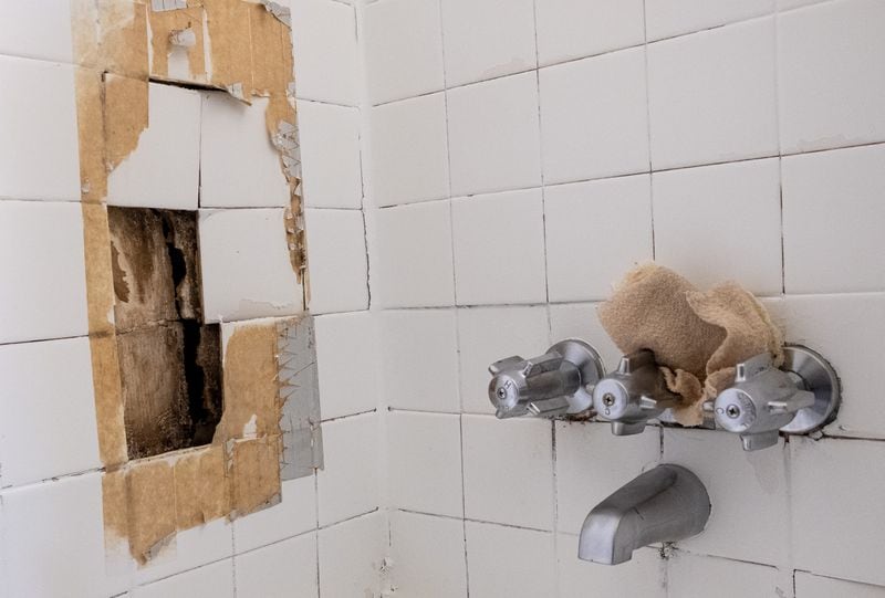 201218-Atlanta-Ana Corpus has repeatedly asked her apartment complex management to repair the crumbling wall in her shower. Ben Gray for the Atlanta Journal-Constitution