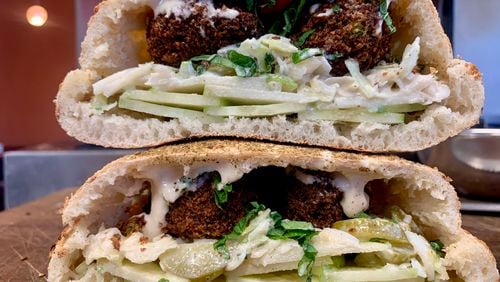 The Hulk sandwich at Firewall features a house-made pita stuffed with browned, crisp spheres of falafel and green condiments. Courtesy of Sam Eidus