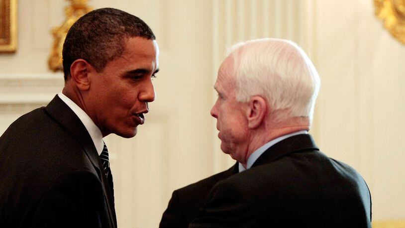 Former President Barack Obama (L) talks with Sen. John McCain (R-AZ) after a meeting with a bipartisan group of Senators and members of Congress in the State Dining Room at the White House June 25, 2009. (Photo by Chip Somodevilla/Getty Images)