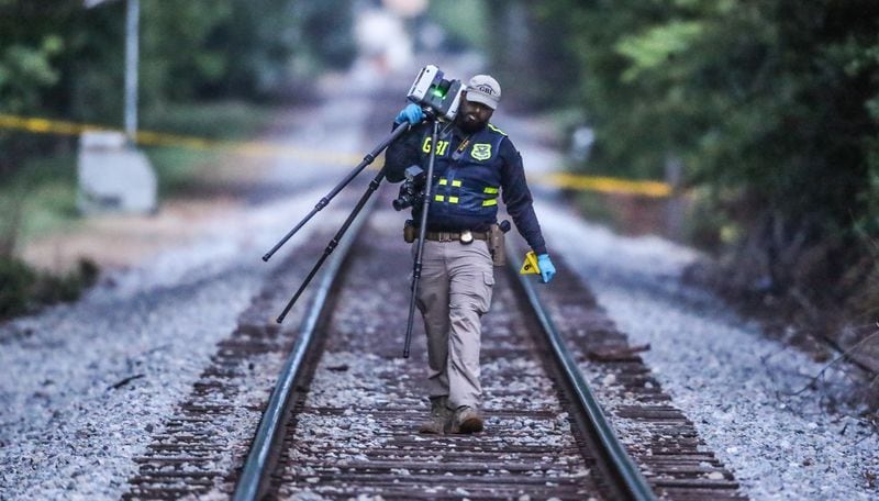 GBI agents focused their investigation along the railroad tracks that divide West Howard and West College avenues, where the suspect ran after crashing his car.