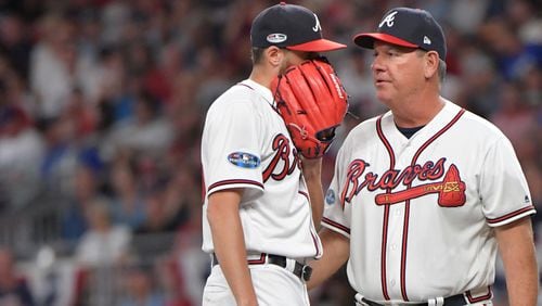 Atlanta Braves pitching coach Chuck Hernandez talks with relief pitcher Kevin Gausman after giving up a two-run single in the third inning against the Los Angeles Dodgers during Game 3 of a National League Division Series  game Friday, Oct. 7, 2018, in Atlanta.