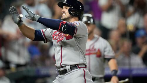 The Braves' Adam Duvall celebrates as he crosses home plate after hitting a two-run home run off Colorado Rockies relief pitcher Yency Almonte in the fifth inning Thursday night in Denver. (AP Photo/David Zalubowski)