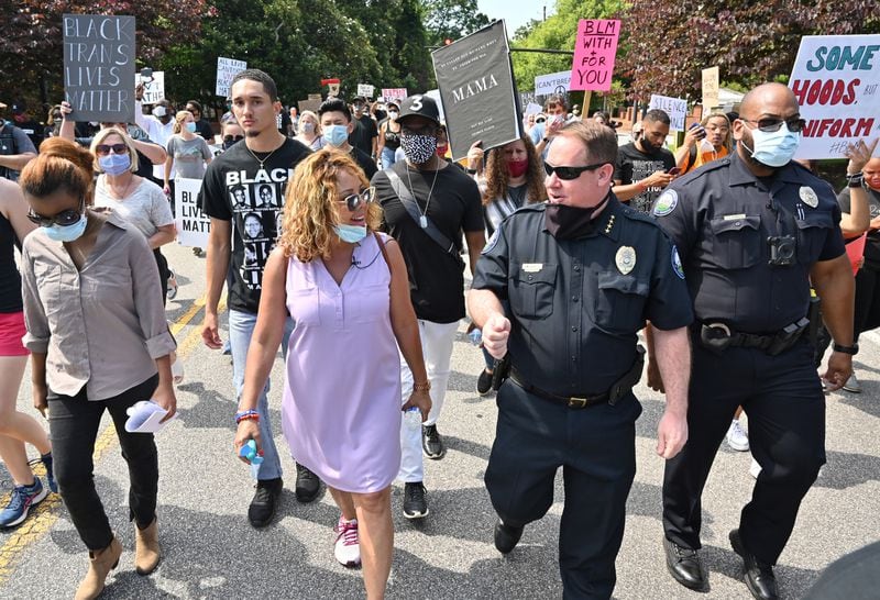 June 13, 2020 Roswell - Congresswoman Lucy McBath (left) and Roswell Police Chief James Conroy talk as they march with peaceful protesters during a Solidarity March in downtown Roswell on Saturday, June 13, 2020. Hundreds joined Pastor Lee Jenkins and Roswell Police Chief James Conroy for a Solidarity March on Saturday, June 13 at 10 am. Pastor Jenkins is organizing the march to protest racism and police brutality. (Hyosub Shin / Hyosub.Shin@ajc.com)