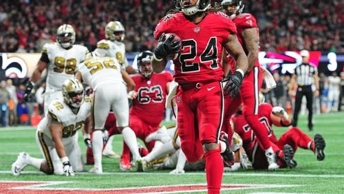ATLANTA, GA - DECEMBER 7: Devonta Freeman #24 of the Atlanta Falcons carries the ball for a touchdown against the New Orleans Saints at Mercedes-Benz Stadium on December 7, 2017 in Atlanta, Georgia. (Photo by Scott Cunningham/Getty Images)
