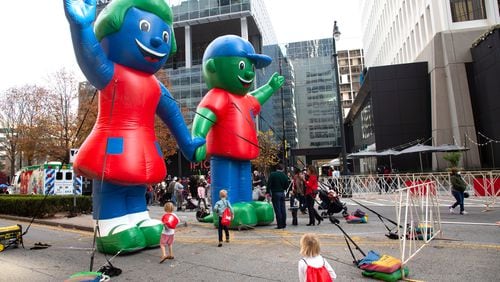 Children play around Large blowups of Hope and Will during the Children’s Healthcare of Atlanta Holiday Experience Saturday, December 4, 2021.  STEVE SCHAEFER FOR THE ATLANTA JOURNAL-CONSTITUTION
