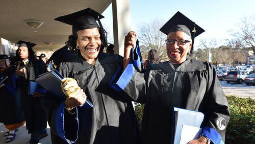 April Lewis (left), 64, and her sister Mae Brown, 67, celebrate after the fall 2017 commencement at Georgia State University’s Perimeter campus on Tuesday, Dec. 12, 2017. It’s taken them a few years to graduate since they began taking college courses in the 1970s. HYOSUB SHIN / HSHIN@AJC.COM