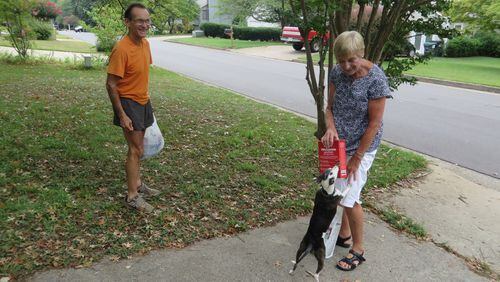 Eduardo Gomez of Johns Creek laughs as his miniature greyhound Karissma greets Christa Cristo, who is delivering dog food and treats donated through the Senior Services North Fulton Meals on Wheels for Pets program. CONTRIBUTED BY LAURA BERRIOS