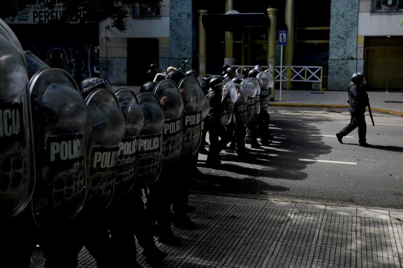 Police advance to disperse an anti-government protest against food scarcity at soup kitchens and against economic reforms proposed by President Javier Milei in Buenos Aires, Argentina, Wednesday, April 10, 2024. (AP Photo/Natacha Pisarenko)