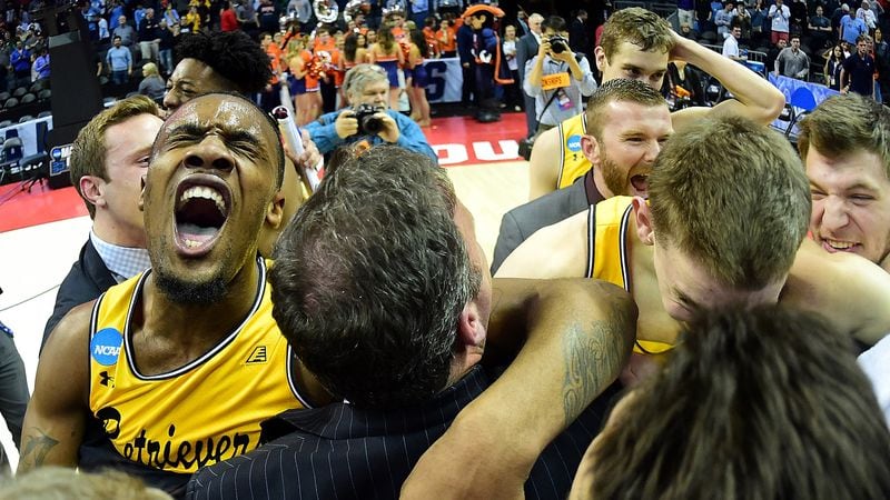Arkel Lamar(left), of the UMBC Retrievers, celebrates their 74-54 victory over top-seeded Virginia during the first round of the 2018 NCAA Men's Basketball Tournament March 16, 2018, in Charlotte, N.C.