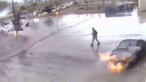 A car burns in a parking lot behind a Walmart in Santa Fe last month.