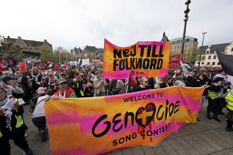 Protesters hold a banner with the words in Swedish "No To Genocide" during a Pro-Palestinian demonstration for excluding Israel from Eurovision ahead of the second semi-final at the Eurovision Song Contest in Malmo, Sweden, Thursday, May 9, 2024. (AP Photo/Martin Meissner)