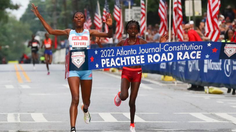 First place finisher in the Woman's Elite division, Senbere Teferi, crosses the finish line ahead of Irine Cheptai in the 53rd running of the Atlanta Journal-Constitution Peachtree Road Race in Atlanta on Monday, July 4, 2022. (Curtis Compton / Curtis.Compton@ajc.com)