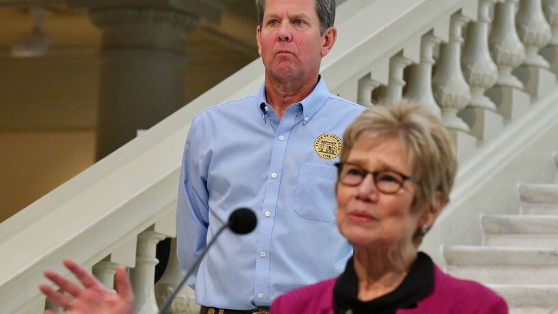 Dr. Kathleen Toomey, commissioner of Georgia Department of Public Health, speaks as Governor Brian Kemp looks during a press briefing to update on COVID-19 at the Georgia State Capitol on May 12, 2020. (Hyosub Shin / Hyosub.Shin@ajc.com)