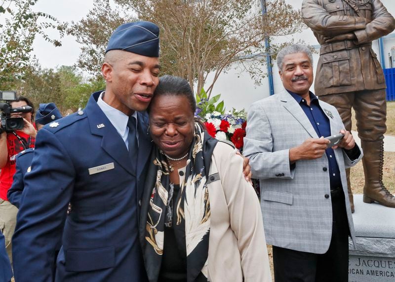 Robins AFB -  Harriett Bullard White, a descendent of Eugene Bullard, gets a hug from Lt. Col. Christopher Banks, one of the project officers, after the unveiling. Georgia's WWI Centennial Commission unveiled a statue of Eugene Bullard, a war hero from Columbus and the first black military pilot in the world, Oct. 9, 2019, at Museum of Aviation at Robins Air Force Base Bob Andres / robert.andres@ajc.com