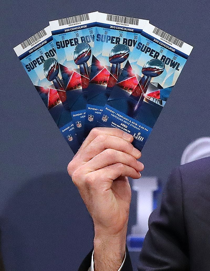 Michael Buchwald, NFL Senior Counsel, holds up real Super Bowl tickets during the National Football League and law enforcement agencies press conference announcing the latest results of seizures of counterfeit game-related merchandise and tickets during a press conference at the Georgia World Congress Center on Thursday, Jan. 31, 2019, in Atlanta. (Curtis Compton/ccompton@ajc.com)