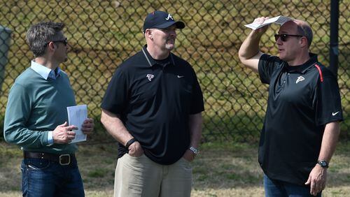 Atlanta Falcons general manager Thomas Dimitroff (from left), head coach Dan Quinn and assistant general manager Scott Pioli confer during Pro Day at the University of Georgia Wednesday, March 16, 2016, in Athens.