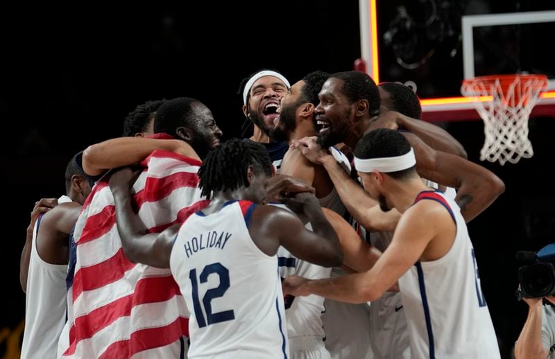 United States' players celebrate after their win in the men's basketball gold medal game against France at the 2020 Summer Olympics, Saturday, Aug. 7, 2021, in Saitama, Japan. (AP Photo/Eric Gay)