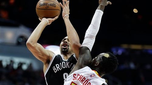 Brooklyn Nets’ Spencer Dinwiddie, left, is fouled by Atlanta Hawks’ Dennis Schroeder as he shoots during the second quarter of an NBA basketball game in Atlanta, Wednesday, March 8, 2017. (AP Photo/David Goldman)