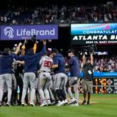 Atlanta Braves players and coaches celebrate after clinching their sixth consecutive NL East title by defeating the Philadelphia Phillies in a baseball game, Wednesday, Sept. 13, 2023, in Philadelphia. (AP Photo/Matt Slocum)