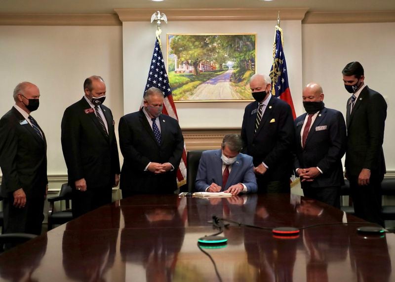 Gov. Brian Kemp signs into law Senate Bill 202, Georgia's new election statute, during a ceremony behind closed doors at the state Capitol.