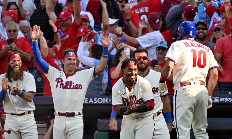 Phillies catcher J.T. Realmuto (10) celebrates an inside-the-park home run against the Braves during the third inning Saturday in Game 4 of the NLDS. (Hyosub Shin / Hyosub.Shin@ajc.com)