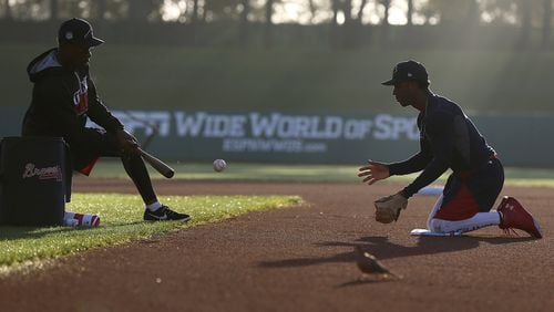 Atlanta Braves third-base coach Ron Washington hits short-hop grounders to second-base prospect Ozzie Albies at sunrise during a recent spring-training workout. (Curtis Compton/ccompton@ajc.com)