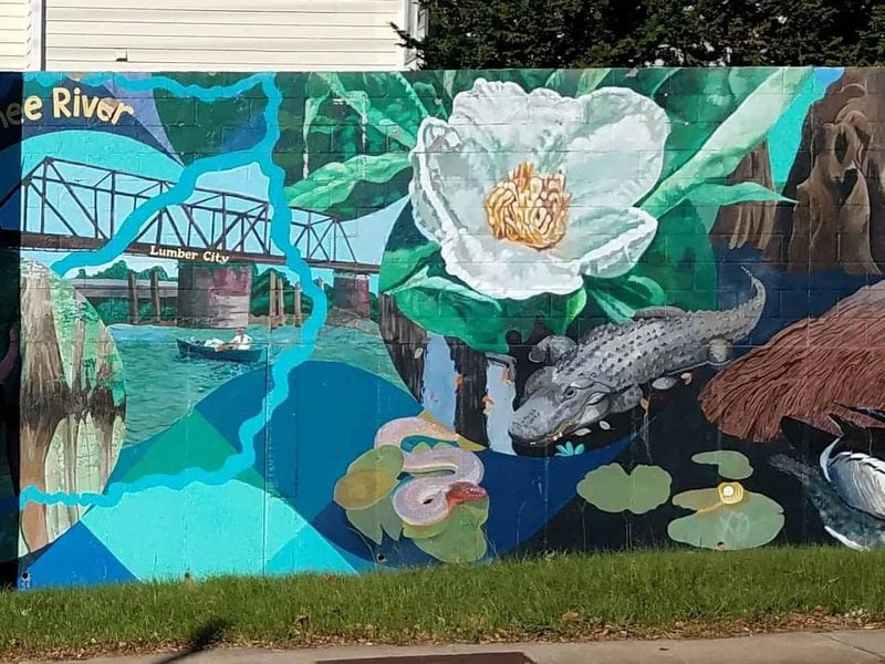 “Native Waters,” the 340-foot-long mural along DeKalb Avenue in the Lake Claire neighborhood, is among the most senior of Atlanta murals. Designed by David Fichter, it was completed by a host of volunteers. CONTRIBUTED: ART RUDICK