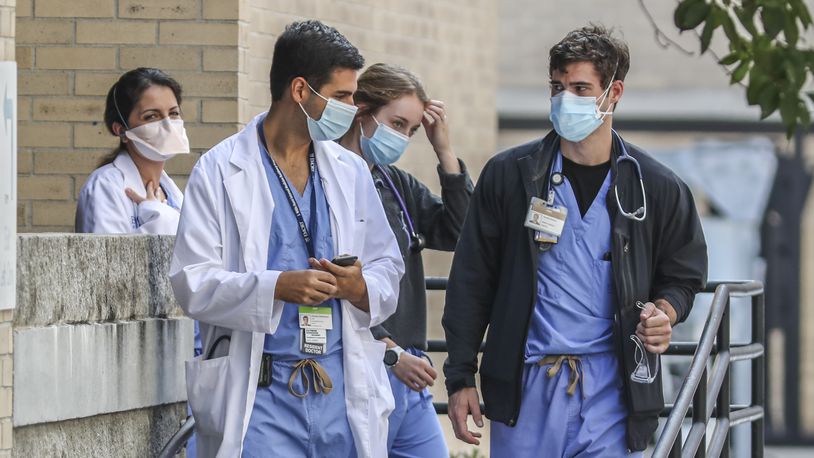 Medical workers move between buildings at Grady Memorial Hospital in downtown Atlanta on Thursday, Aug. 26, 2021. (John Spink / John.Spink@ajc.com)