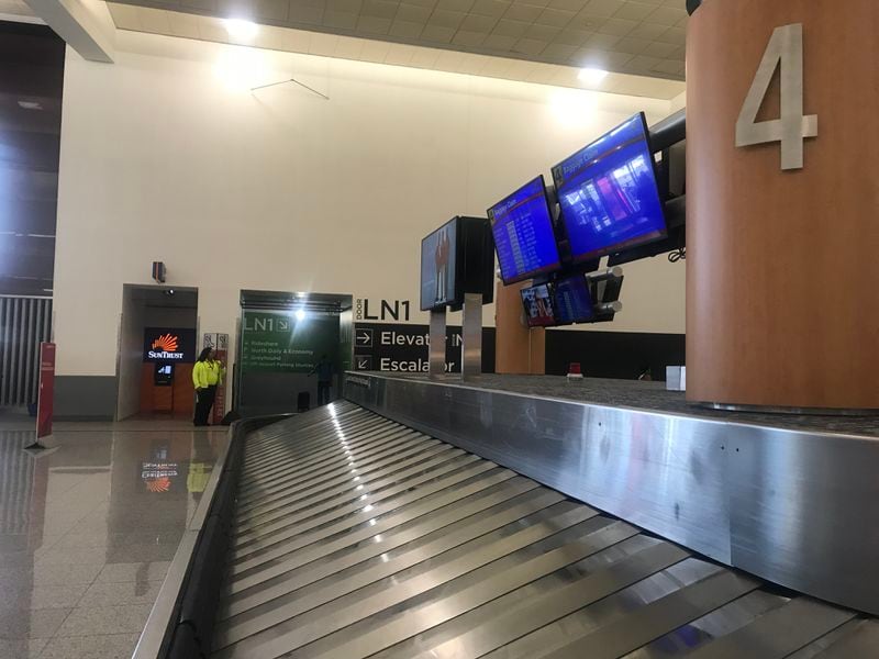 The entrance to the escalators down to door LN1 is marked in green, behind baggage carousel 4 at domestic Terminal North.