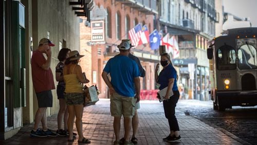 SAVANNAH, GA - Sept. 4, 2020: CoVid Resource Team member Nicole Bush, right, reminds a group of people to wear masks while visiting River Street in historic downtown Savannah. (AJC Photo/Stephen B. Morton)