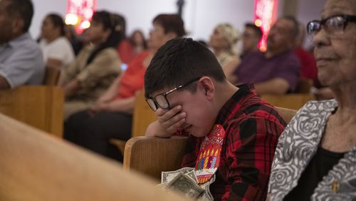 Thomas Ledesma cries during a Mass honoring the victims of the El Paso mass shooting, at El Buen Pastor Mission on the outskirts of El Paso, Texas, on Sunday, Aug. 11, 2019.