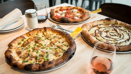 Rize Asian BBQ Chicken signature pizza with green chili sauce, Classic Margherita pizza with fire roasted tomatoes, and Waverly signature pizza with prosciutto, cheeses, and fig jam. Photo Credit- Mia Yakel.