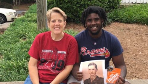 Grady High School principal Betsy Bockman is shown with 2019 graduate Dale Turnipseed, who is holding a photo of 1946 Tech High graduate Jim Logan. To honor Logan on his 91st birthday, his family wanted to give a donation to a current APS student.  Bockman recommended Turnipseed.
