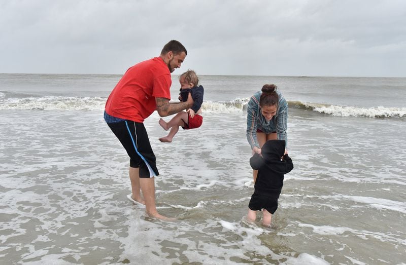 After Hurricane Dorian moved out, Jamey Waters (left) with twin son Thomas and Sarah Beutner with twin son Tanner, both 1 1/2, enjoy a morning in Tybee Island on Thursday, Sept. 5, 2019. HYOSUB SHIN / HYOSUB.SHIN@AJC.COM