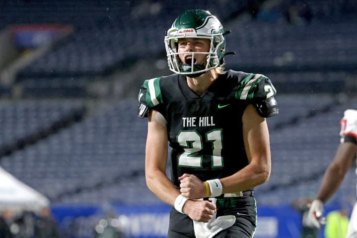 Collins Hill quarterback Sam Horn (21) celebrates his touchdown pass during the first half against Milton in Class 7A state title football game at Georgia State Center Parc Stadium Saturday, December 11, 2021, Atlanta. JASON GETZ FOR THE ATLANTA JOURNAL-CONSTITUTION