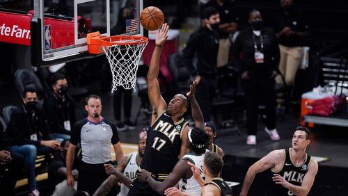 Atlanta Hawks' Onyeka Okongwu (17) reaches for a rebound against the Milwaukee Bucks during the first half of Game 4 of the NBA basketball Eastern Conference finals Tuesday, June 29, 2021, in Atlanta. (AP Photo/Brynn Anderson)