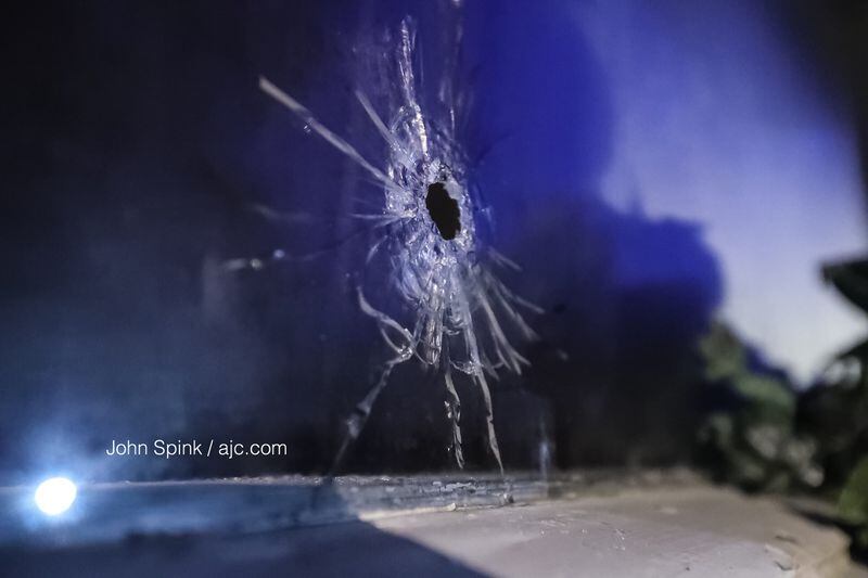 A family was asleep inside their Hall Drive home when someone driving by fired several shots, striking a 19-year-old man. JOHN SPINK / JSPINK@AJC.COM