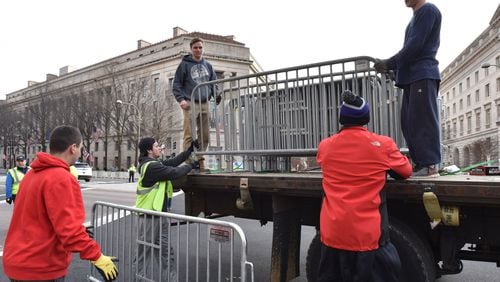 Volunteers and staff set up barricades Thursday in Washington as the city prepares for Friday’s inauguration of Donald Trump as president. HYOSUB SHIN / HSHIN@AJC.COM