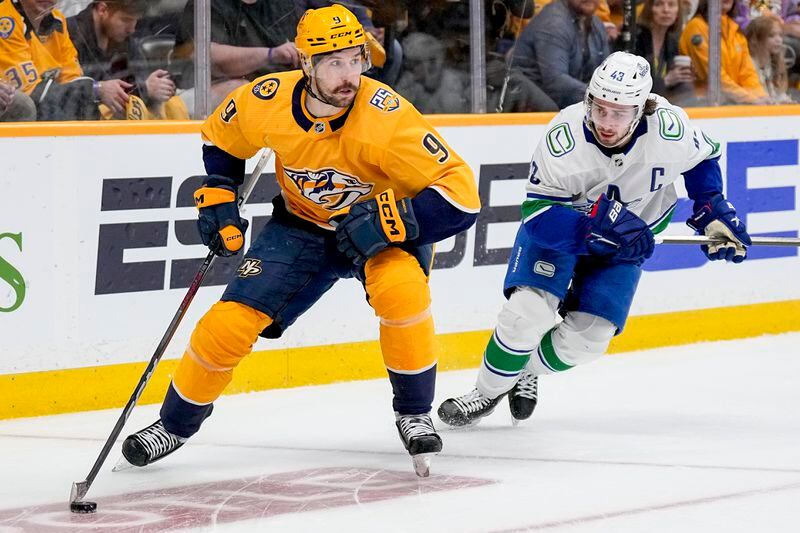 Nashville Predators left wing Filip Forsberg (9) skates the puck past Vancouver Canucks defenseman Quinn Hughes (43) during the second period in Game 6 of an NHL hockey Stanley Cup first-round playoff series Friday, May 3, 2024, in Nashville, Tenn. (AP Photo/George Walker IV)