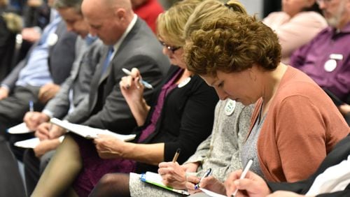 Participants fill in a volunteer form during a kickoff meeting Jan. 11, 2019, of Go Gwinnett, a group pushing for Gwinnett voters to approve of joining MARTA. HYOSUB SHIN / HSHIN@AJC.COM