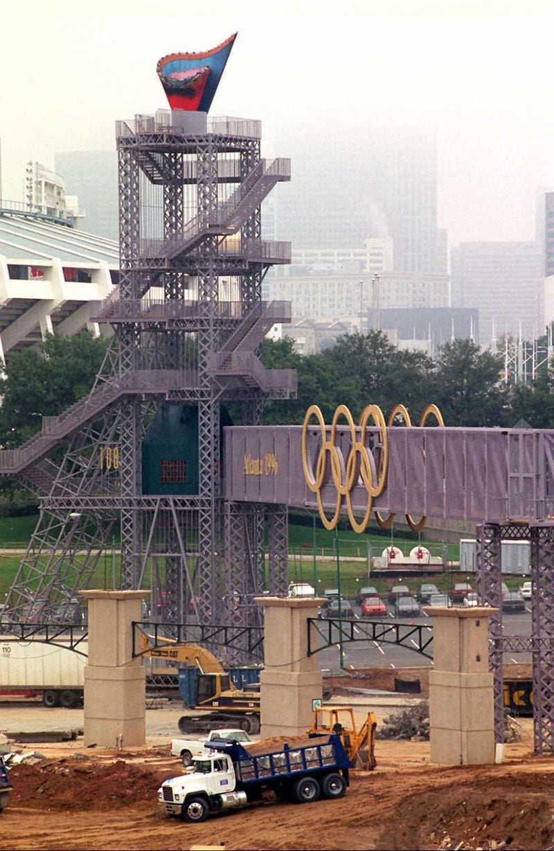 WIth the Olympic Caldron in the background, dirt is brought in to backfill the huge plaza that will lay beyond the outfield of the new baseball park, formerly the Olympic stadium, on October 1, 1996 in Atlanta, Georgia. Used for the Opening and Closing Ceremonies, as well as track and field during the Games, the stadium was reconfigured and became the home of the Atlanta Braves for 20 years. (AJC Staff Photo/Joey Ivansco)