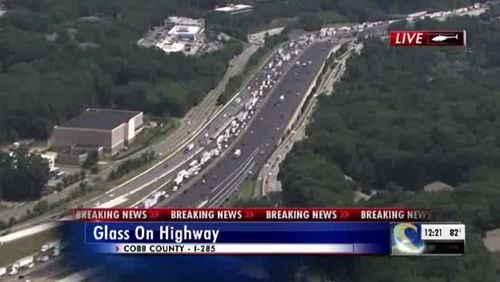 Traffic on the I-285 Outer Loop stacked up behind an effort to clear shattered glass on the interstate.