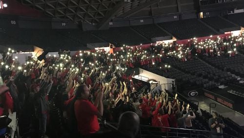 Spectators inside the University of Georgia's Stegeman Coliseum turn the lights on their cell phones on at the end of the third quarter in support of their beloved Bulldogs. ERIC STIRGUS / ESTIRGUS@AJC.COM