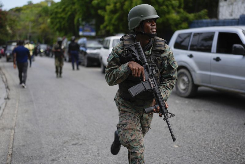 Soldiers deploy outside the Prime Minister's office in Port-au-Prince, Haiti, Thursday, April 25, 2024. A transitional council tasked with selecting a new prime minister and cabinet is expected to be sworn-in on Thursday. (AP Photo/Ramon Espinosa)