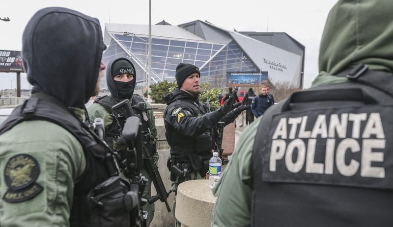 January 8, 2018 Atlanta: Atlanta police department security maintained high visibility in the stadium perimeter in downtown Atlanta on Monday, Jan. 8, 2018. The Alabama Crimson Tide were 3.5-point favorites going into Monday night’s College Football Playoff Championship against the Georgia Bulldogs at Atlanta’s Mercedes-Benz Stadium. Gov. Nathan Deal ordered non-essential state offices from Columbus to Augusta and northward to close Monday, and city of Atlanta officials announced a similar order for local offices. Officials began announcing closures to ease traffic burdens early, in large part because of the game. The 8pm kick off for the championship, will see US President Donald Trump in attendance. Kendrick Lamar was scheduled to perform a free halftime concert at Centennial Olympic Park. JOHN SPINK/JSPINK@AJC.COM