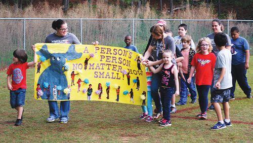 Teacher Jennifer Nettuno and her class at Boston Elementary School, Woodstock, rally behind a banner during the recent Relay for Life, a walkathon fundraiser for the American Cancer Society. The entrance to their school is to be renovated in the Cherokee County schools’ 2018 budget plan. CHEROKEE COUNTY SCHOOLS